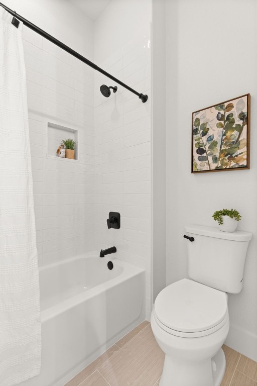 bathroom with shower / tub combo and toilet