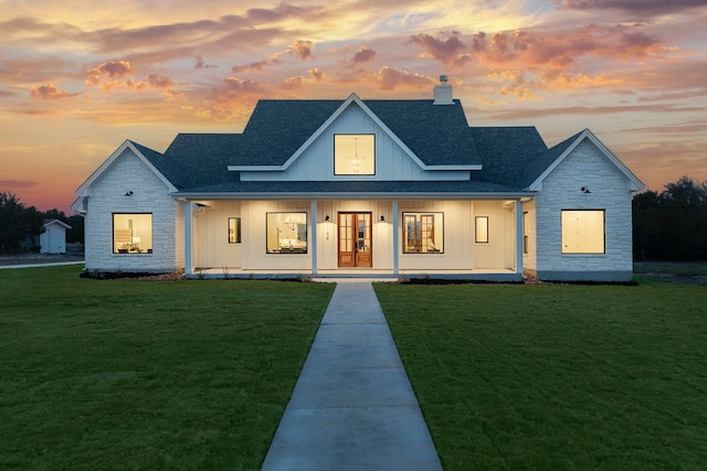 view of front of home with a porch and a yard