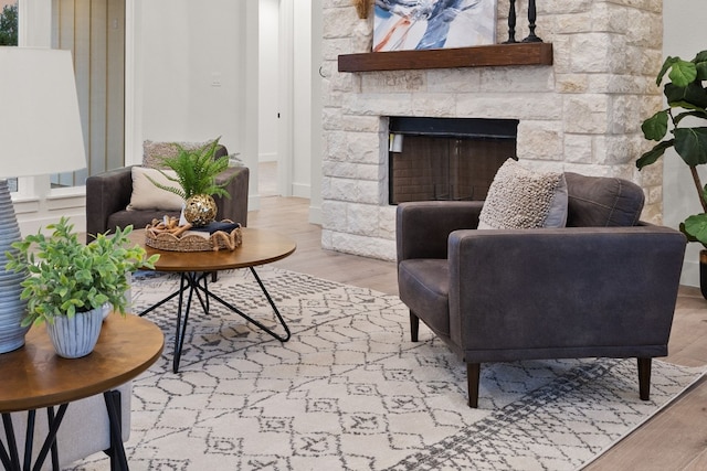 interior space featuring a stone fireplace and light hardwood / wood-style flooring