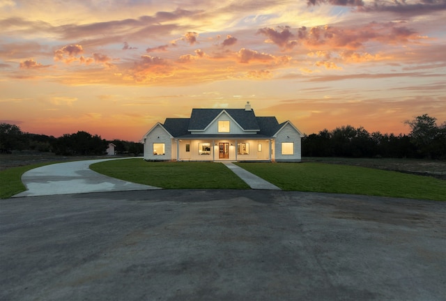 new england style home featuring a yard