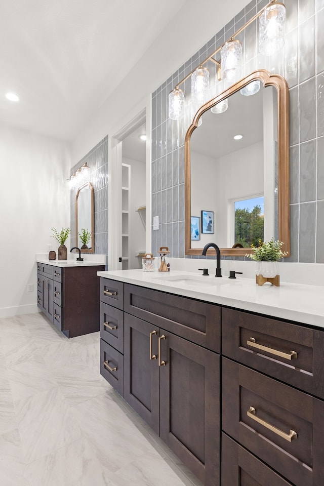 bathroom with vanity and tile walls