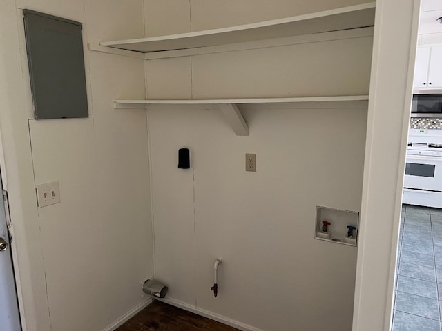 laundry area featuring washer hookup and dark tile floors