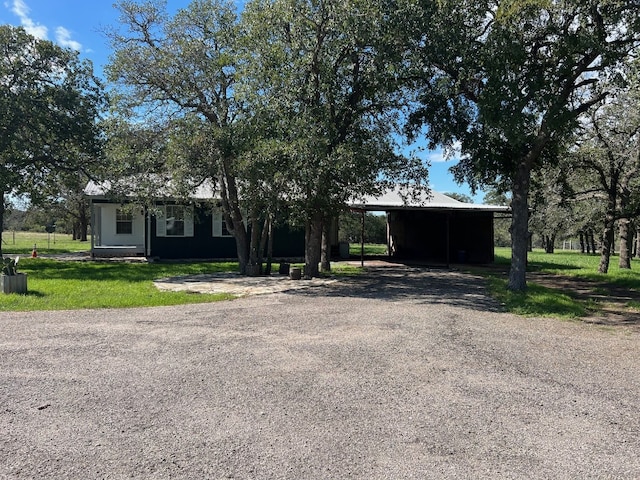 view of front of house with a front yard and a carport