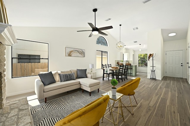 living room with ceiling fan, hardwood / wood-style floors, and high vaulted ceiling