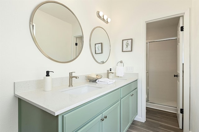 bathroom with vanity, wood-type flooring, and an enclosed shower