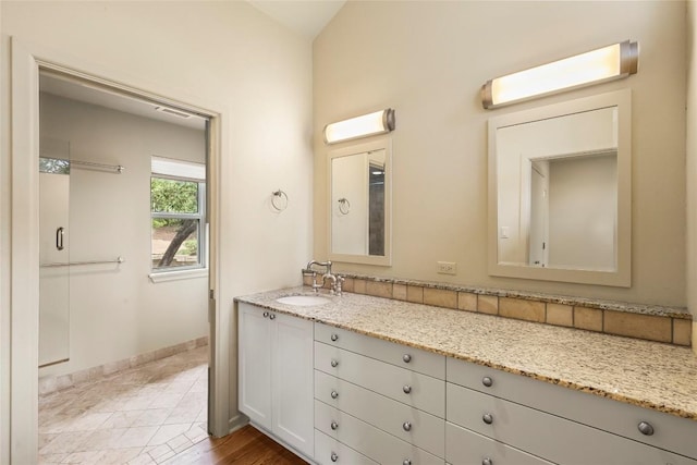 bathroom featuring baseboards and vanity