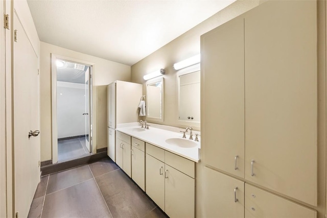 bathroom featuring double vanity, tile patterned flooring, and a sink