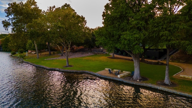 view of home's community featuring a yard and a water view