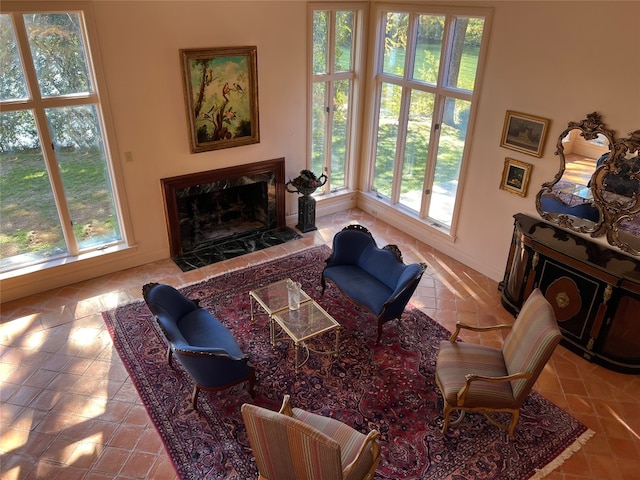 tiled living room featuring a premium fireplace