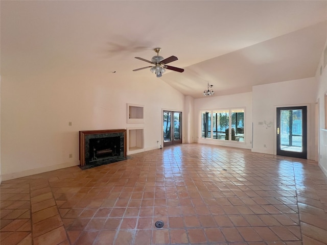 unfurnished living room featuring tile patterned floors, ceiling fan with notable chandelier, a fireplace, and vaulted ceiling