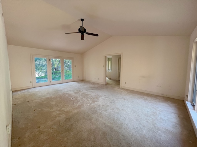 carpeted spare room with ceiling fan and lofted ceiling