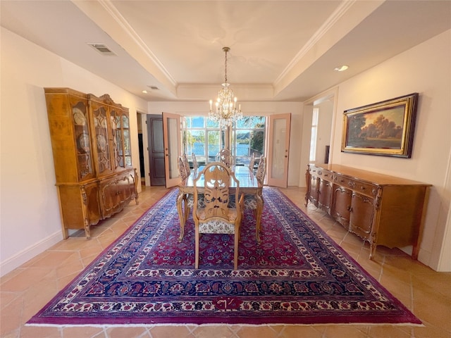 dining area featuring an inviting chandelier, crown molding, and a tray ceiling