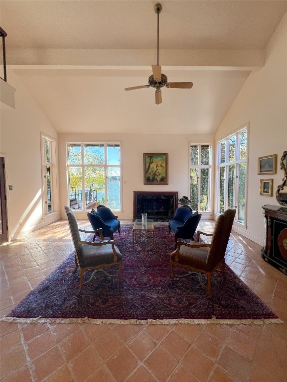 living room featuring vaulted ceiling with beams and ceiling fan