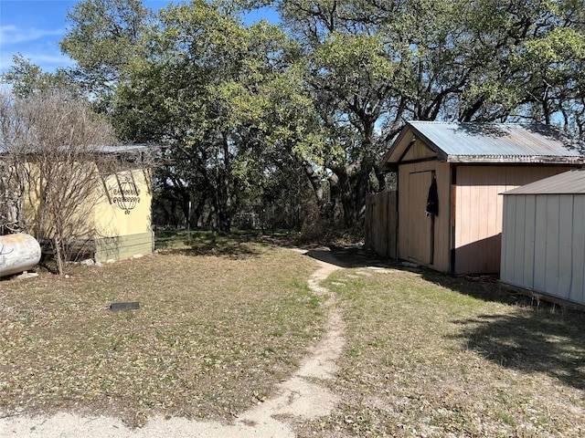 view of yard featuring an outbuilding and a shed