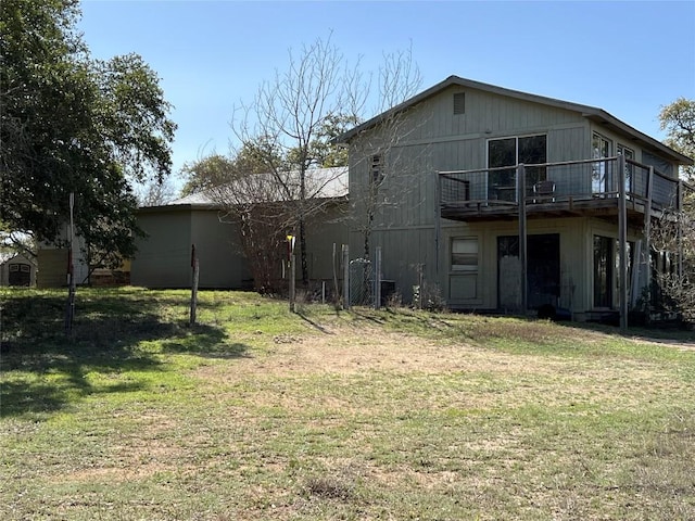 rear view of house with a yard