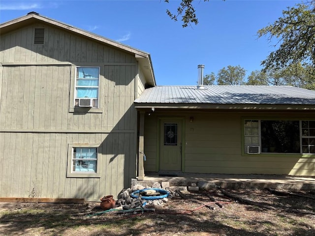 rear view of property featuring metal roof