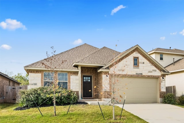 view of front of property featuring a garage and a front lawn