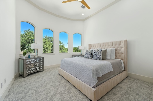 carpeted bedroom featuring ceiling fan and a high ceiling