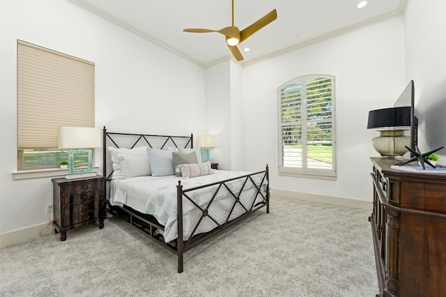 carpeted bedroom with ceiling fan and crown molding