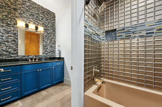 bathroom featuring vanity and tiled shower / bath