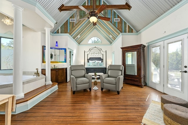 sitting room with hardwood / wood-style floors, high vaulted ceiling, and plenty of natural light