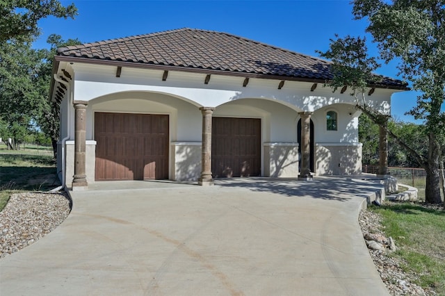 mediterranean / spanish-style home featuring a garage