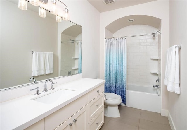 full bathroom featuring baseboards, shower / bath combo with shower curtain, toilet, tile patterned floors, and vanity