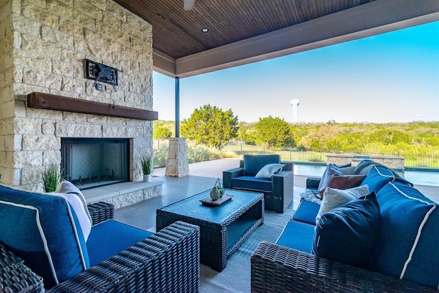 view of patio featuring an outdoor living space with a fireplace and fence