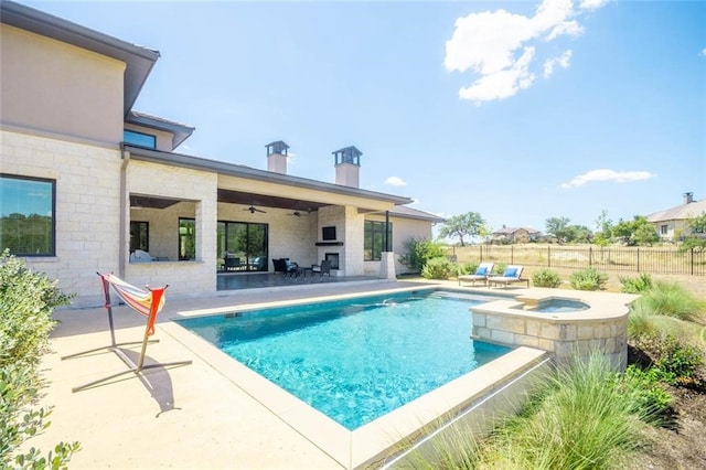 view of pool with a ceiling fan, a patio, fence, and a pool with connected hot tub