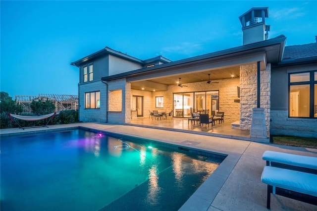 outdoor pool featuring ceiling fan and a patio area