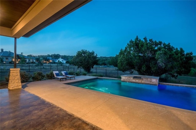 view of pool with a patio, a fenced backyard, and a pool with connected hot tub