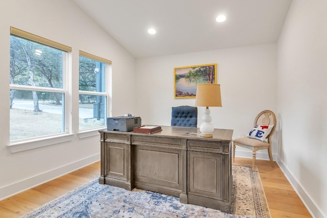 office area featuring lofted ceiling and light hardwood / wood-style flooring