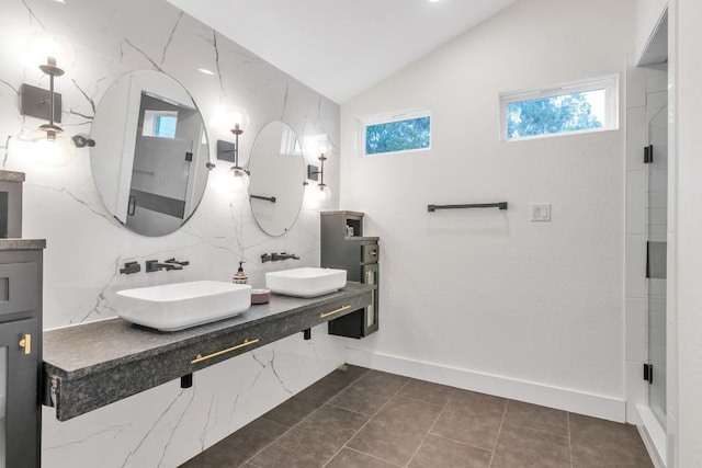 bathroom featuring tile patterned floors, vanity, lofted ceiling, and walk in shower