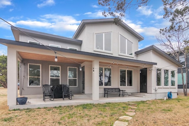 rear view of property with a porch and a yard