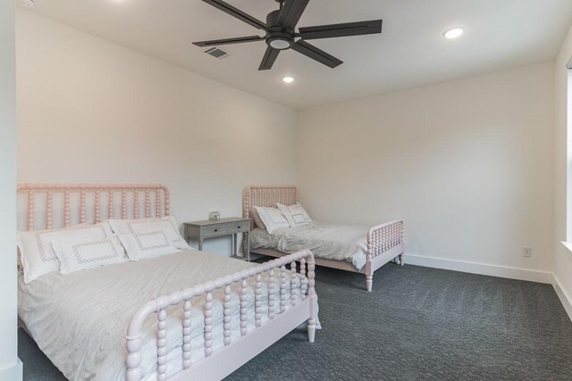 bedroom featuring dark colored carpet and ceiling fan