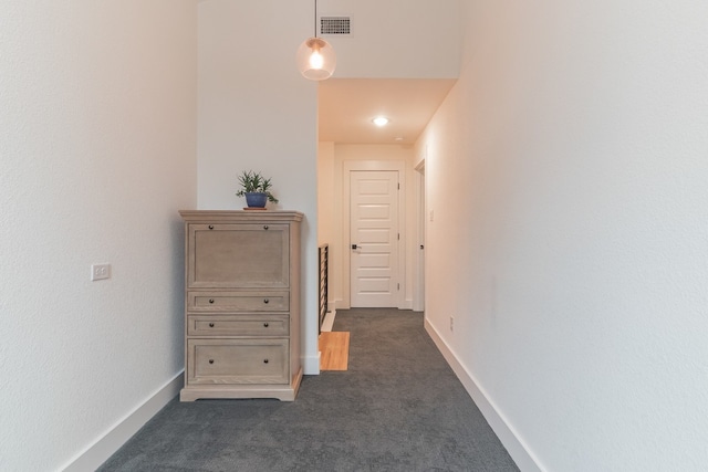 hallway with dark carpet