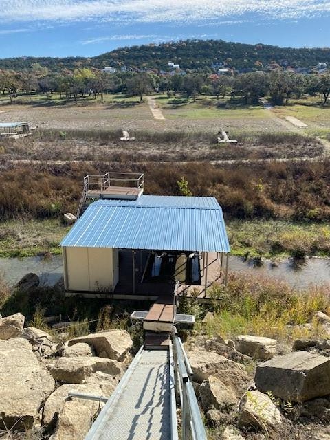 entry to storm shelter with a rural view