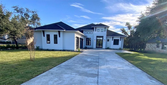 view of front of house featuring a garage and a front yard