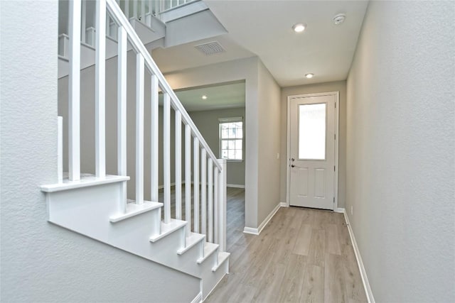 entrance foyer with recessed lighting, visible vents, stairway, light wood-type flooring, and baseboards