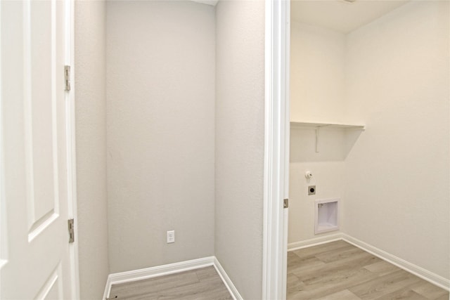 laundry room with light hardwood / wood-style flooring and hookup for an electric dryer