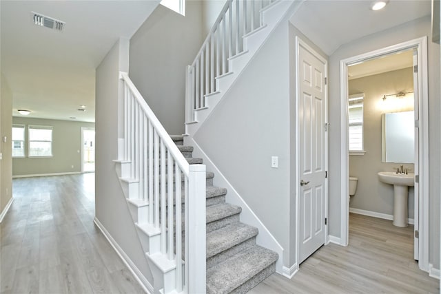 staircase with light hardwood / wood-style flooring