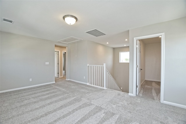 empty room featuring light carpet