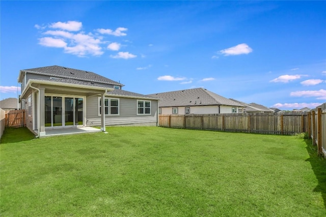 back of house with a lawn, a patio area, and a fenced backyard