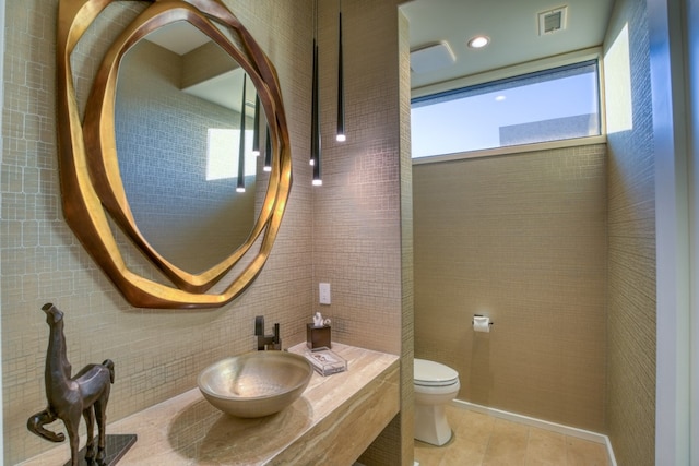 bathroom featuring sink, tile walls, toilet, and tile patterned floors