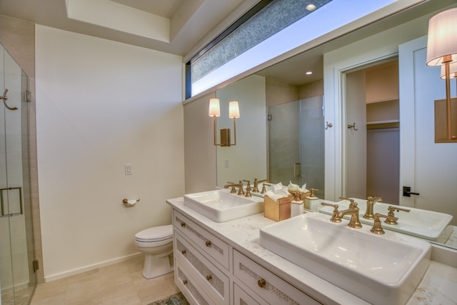 bathroom featuring vanity, toilet, tile patterned floors, and an enclosed shower