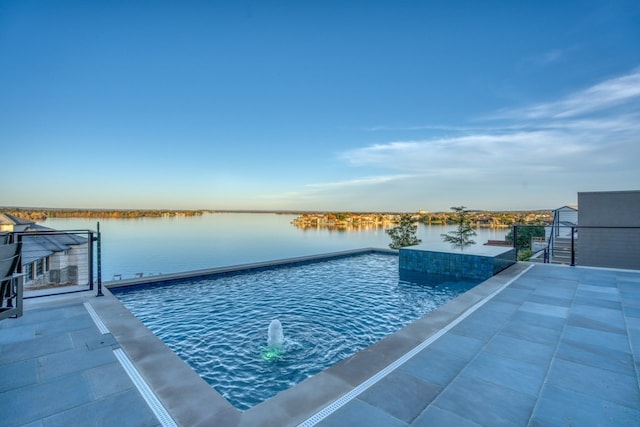 view of swimming pool featuring a water view