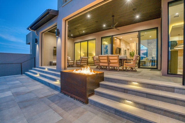 exterior space with ceiling fan and a fire pit