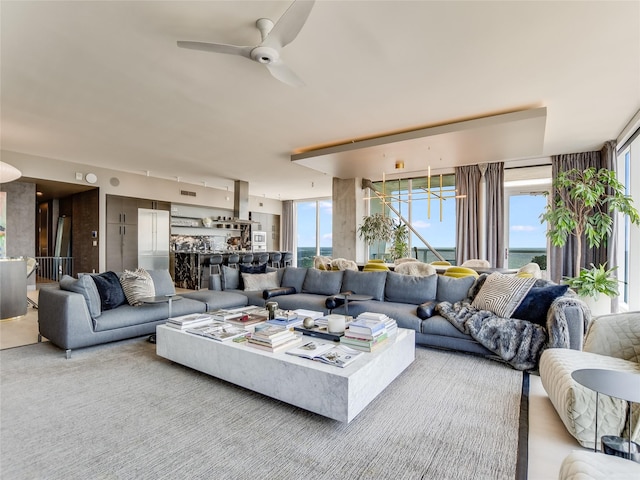 living room featuring a water view and ceiling fan