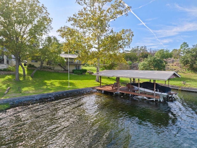 view of dock featuring a lawn and a water view