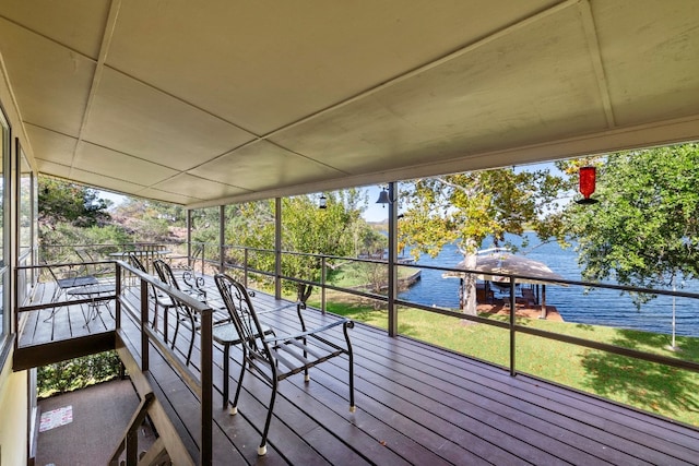 unfurnished sunroom with a water view